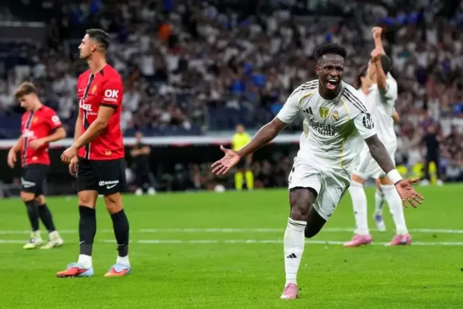 
Pemain Real Madrid, Vinicius Junior, kanan, merayakan gol kedua timnya dalam pertandingan La Liga Spanyol melawan Mallorca di Madrid, Sabtu, 30 Agustus 2025. (AP/Manu Fernandez)